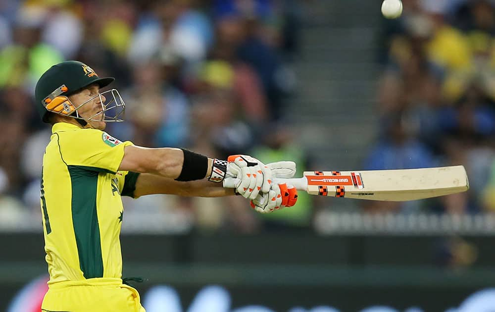 Australia's David Warner hits the ball to the boundary while batting against New Zealand during the Cricket World Cup final in Melbourne, Australia.