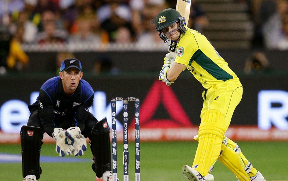 Australia's Steve Smith looks to play a shot as New Zealand wicketkeeper Luke Ronchi watches during the Cricket World Cup final in Melbourne, Australia.