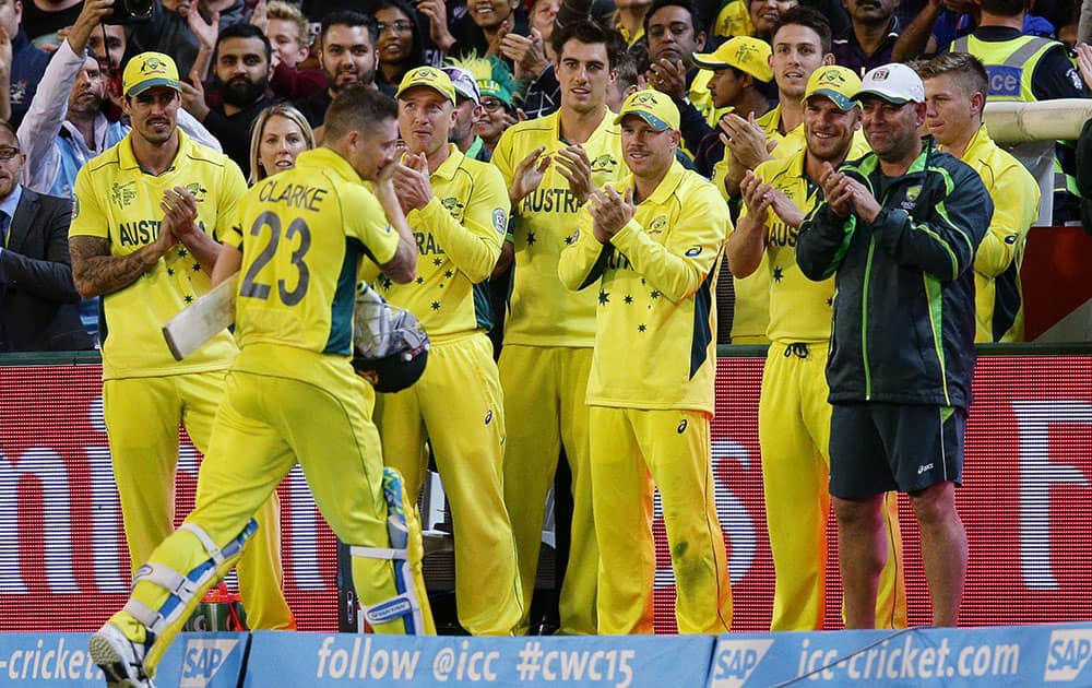 Members of the Australian team clap their captain Australian captain Michael Clarke from the field after his innings of 74 runs while batting against New Zealand during the Cricket World Cup final in Melbourne, Australia.