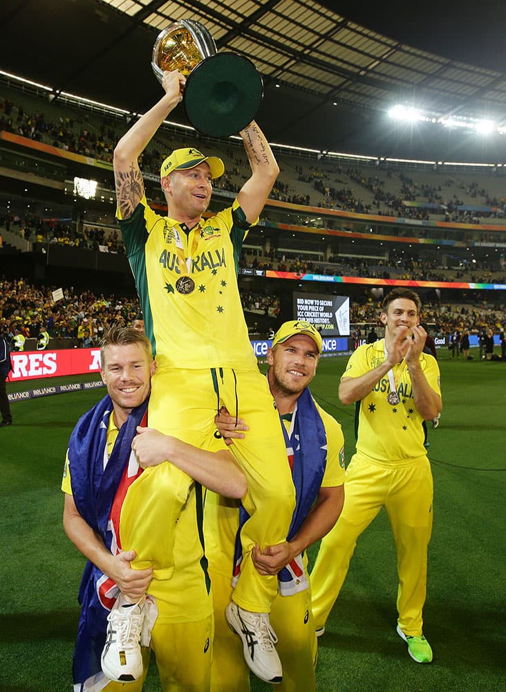 Australian captain Michael Clarke is held aloft by teammates as he celebrates their seven wicket victory over New Zealand to win the Cricket World Cup final in Melbourne, Australia.