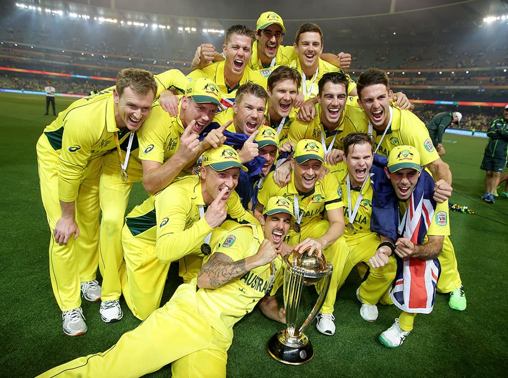 The Australian team pose with their trophy after defeating New Zealand by seven wickets to win the Cricket World Cup final in Melbourne, Australia.