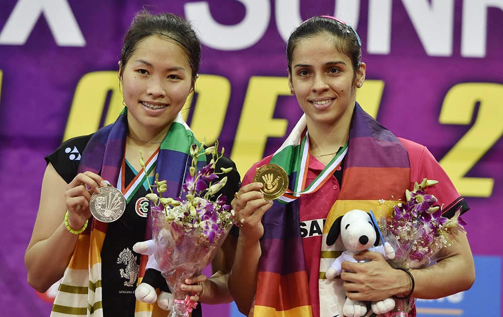 Indian ace shuttler Saina Nehwal with Thailands Ratchanok Intanon, poses with their medals after winning the final match of Yonex Sunrise India Open 2015 in New Delhi.