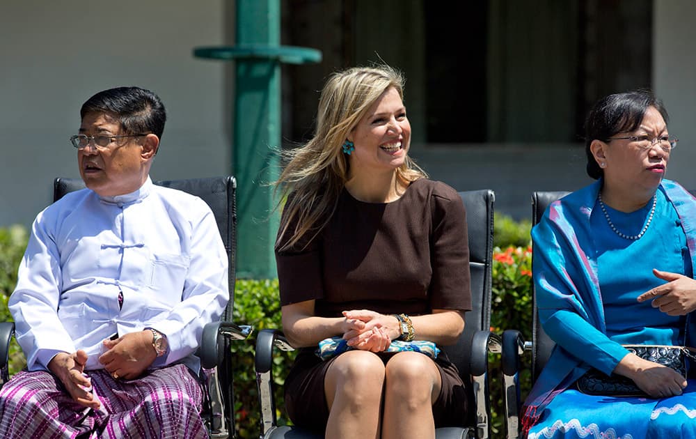 Queen Maxima of the Netherlands, smiles as she prepares to pose for a group photo with Myanmar lawmakers and educationalists after delivering a speech on the importance of access to financial services at the University of Yangon, Myanmar.