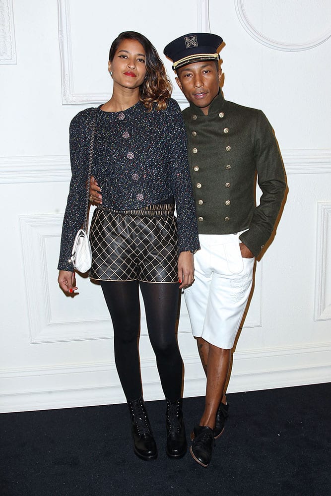 Helen Lasichanh, left, and Pharrell Williams arrive at the Chanel Paris-Salzburg 2014/15 Metiers d’Art Collection fashion show at the Park Avenue Armory in New York.