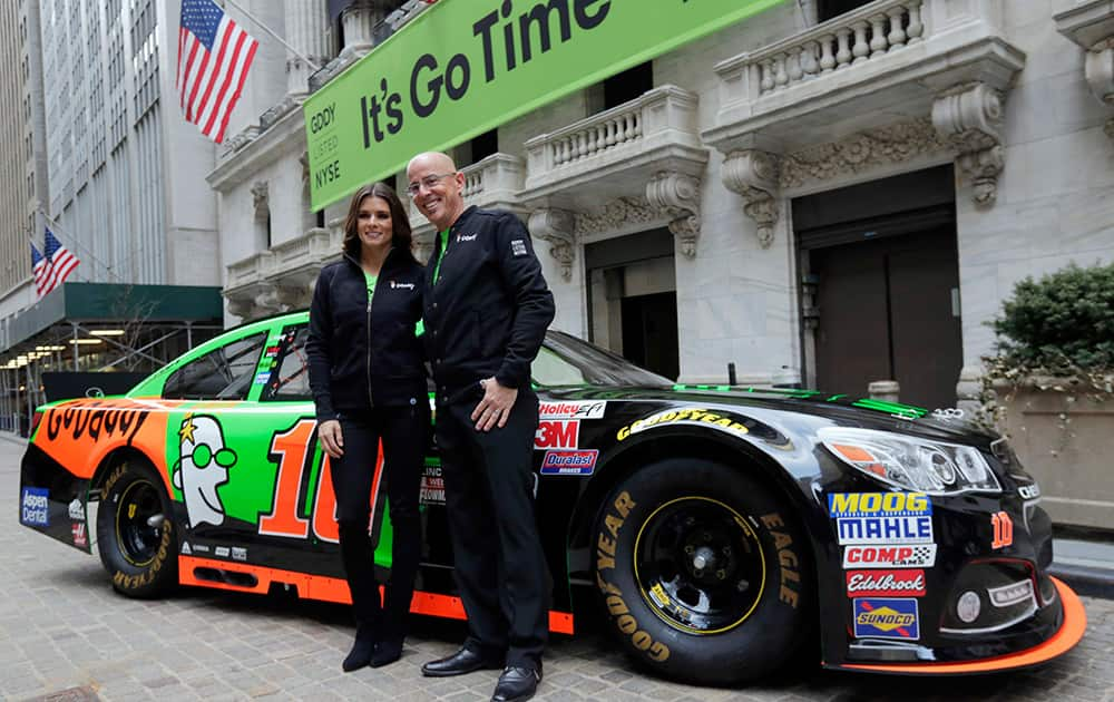 Race car driver Danica Patrick and GoDaddy CEO Blake Irving pose for photos in front of the New York Stock Exchange, before the company's IPO.