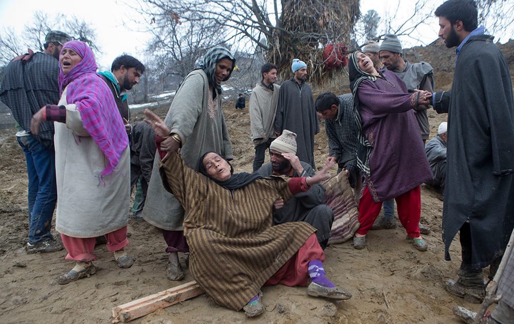 Relatives of landslide victims wail during a mass funeral in the village of Laden some 45 kilometers (28 miles) west of Srinagar, Kashmir.