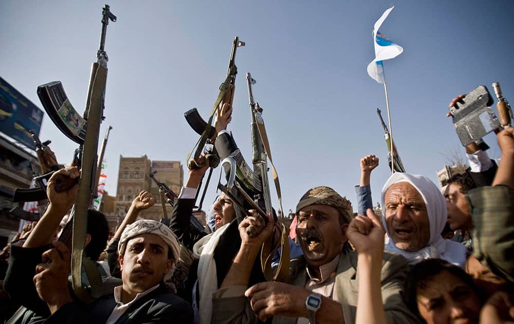 Shiite rebels, known as Houthis, hold up their weapons to protest against Saudi-led airstrikes, during a rally in Sanaa, Yemen. Saudi-led coalition warplanes bombed Shiite rebel positions in both north and south Yemen.