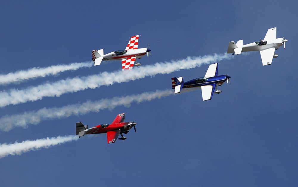 Aircrafts of the British aerobatics team Global Stars perform during the inauguration of an air show in Ahmadabad.