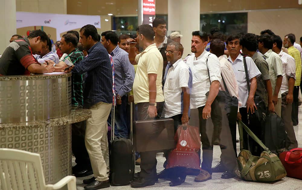 An Indian official checks the paper of Indians who were evacuated from Yemen after arriving at Chhatrapati Shivaji International Airport in Mumbai.