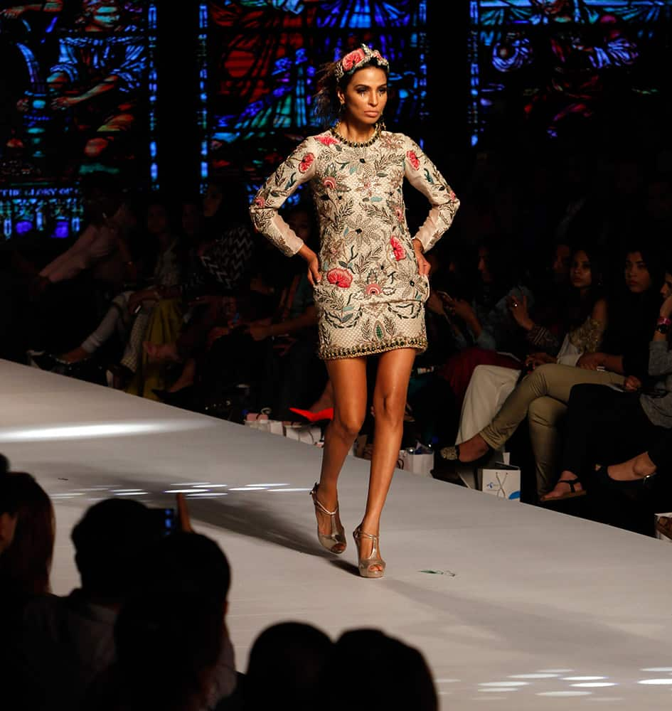 Models present creations by Pakistani designer creations at Pakistan Fashion Week 2015, in Karachi, Pakistan