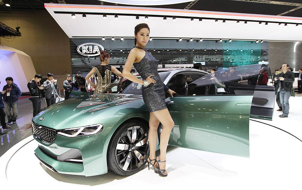 Models pose with a Kia Motors' concept car Novo during a media preview of the Seoul Motor Show in Goyang, South Korea.