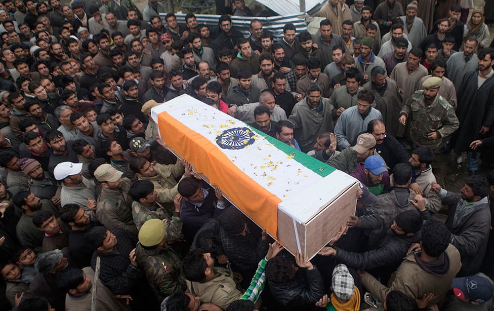 Kashmiri villagers carry the coffin of Mohammad Shafi, an Indian policeman killed in a gunbattle, during his funeral procession in Chenabal, some 21 Kilometers north of Srinagar, Kashmir.