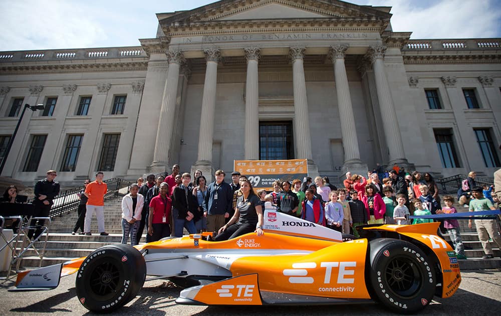 Driver Simona de Silvestro poses for photographs during a news conference, at the The Franklin Institute in Philadelphia.