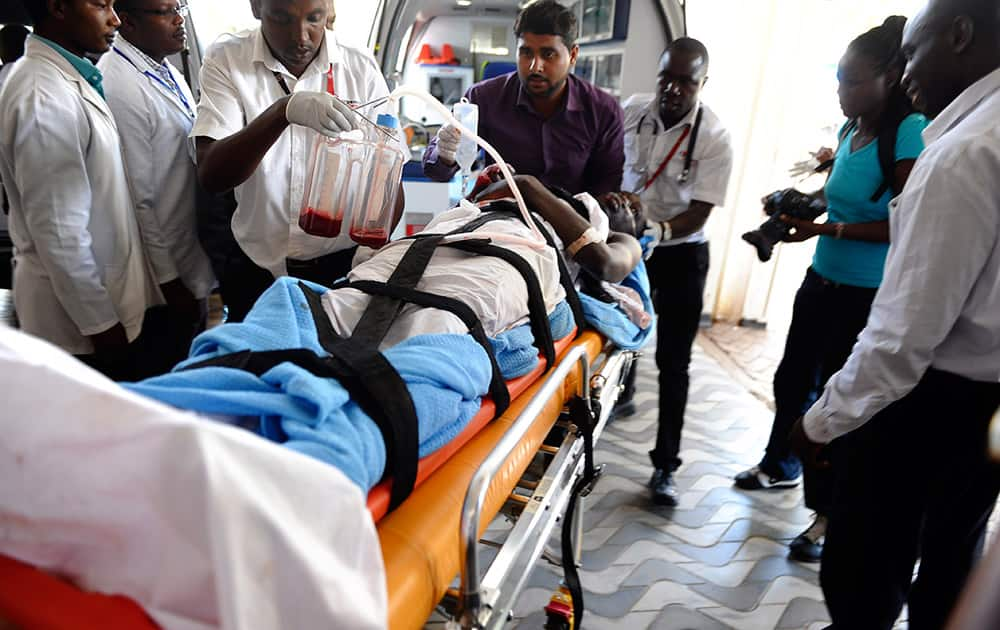 Medics help an injured person at Kenyatta national Hospital in Nairobi, Kenya.