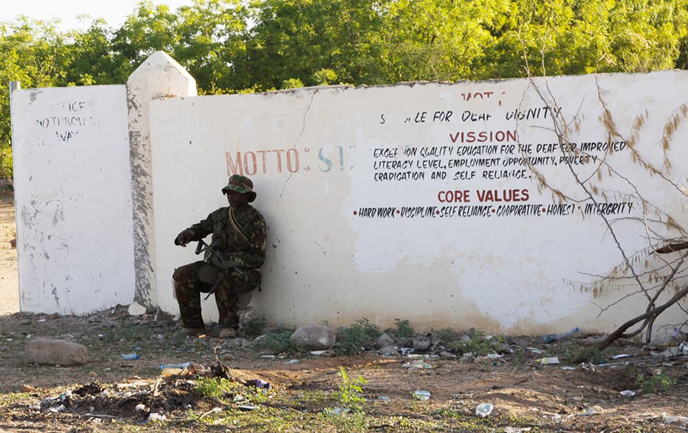 A Kenya Defence Forces soldier secures the area around the Garissa University college, in Garissa, Kenya. Al-Shabab gunmen attacked Garissa University College in northeast Kenya early Thursday, targeting Christians and killing over 100 people and wounding others, according to Kenya's national disaster operations center and the interior minister.