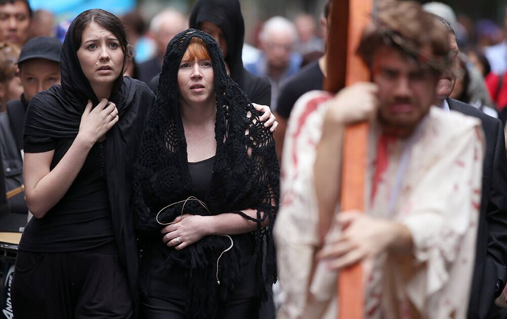 Brendan Paul, plays the part of Jesus as supporters follow during a re-enactment of the crucifixion of Christ in Sydney.