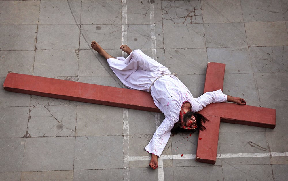 An Indian Christian devotee enacts the crucifixion of Jesus Christ to mark Good Friday at Sacred Heart Church in Hyderabad.