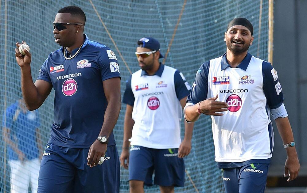 Mumbai Indians players Kieron Pollard with Harbhajan Singh and Rohit Sharma during a practice session in Mumbai.