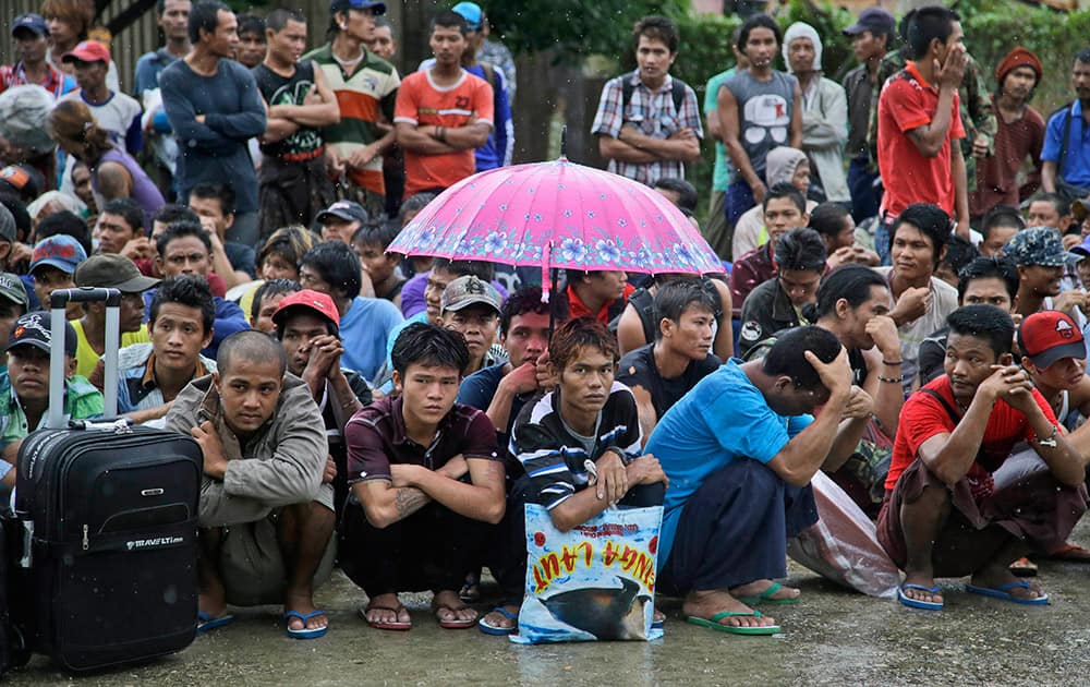 Burmese fishermen wait for their departure to leave the compound of Pusaka Benjina Resources fishing company in Benjina, Aru Islands, Indonesia.