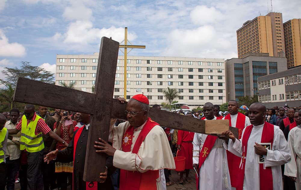 Joined by Christians, Head of the Catholic Church in Kenya, Cardinal John Njue, carries the Cross through the streets of Nairobi, Kenya.