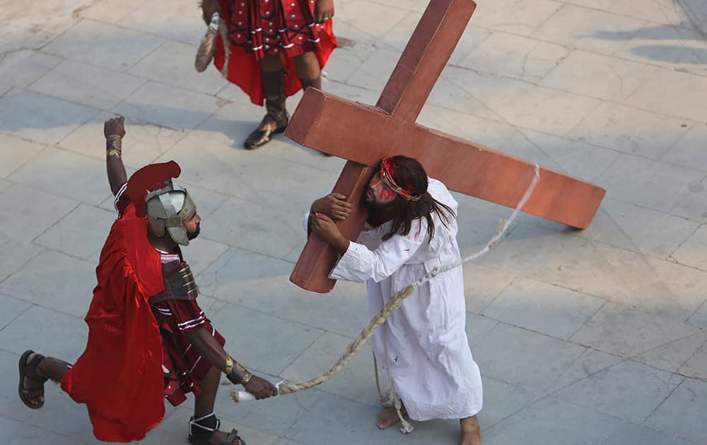 Christian devotees enact the crucifixion of Jesus Christ to mark Good Friday at Sacred Heart Church in Hyderabad.