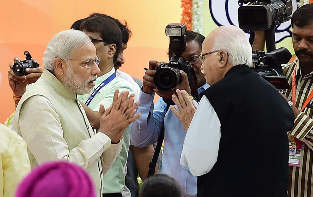 Prime Minister Narendra Modi greets veteran leader L K Advani during the inauguration of the two day National Executive Meeting in Bengaluru.