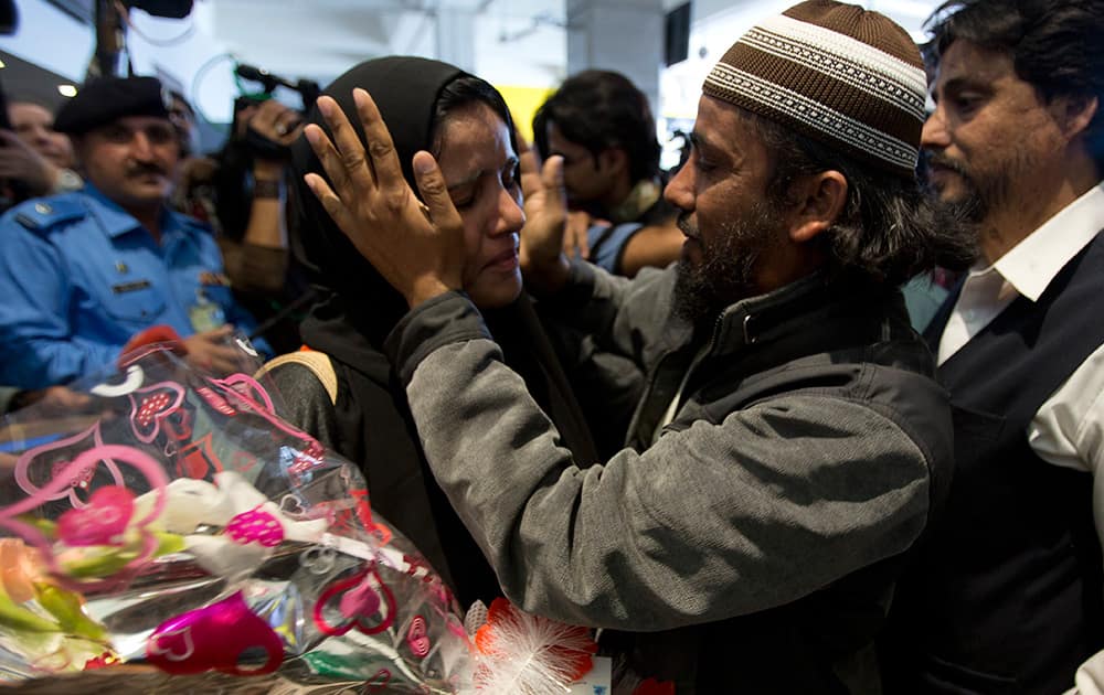 A Pakistani woman evacuated from Yemen is greeted by her family member at Islamabad airport in Pakistan.