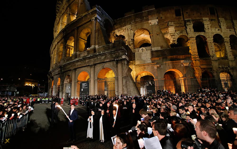 Nuns hold hold the cross during a station of the Via Crucis (Way of the Cross) torchlight procession celebrated by Pope Francis in front of the Colosseum on Good Friday, in Rome