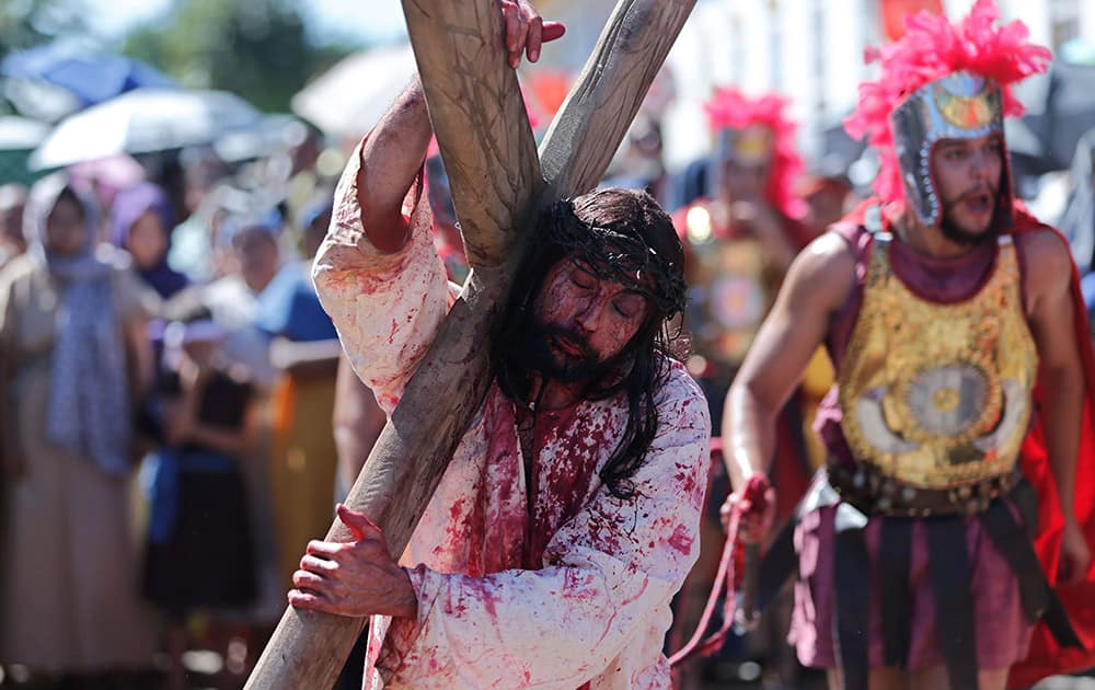 Portraying Jesus Christ, a parishioner reenacts the steps of Jesus' final hours in a Good Friday procession, or the 14 Stations of the Cross, in Pirenopolis, Brazil.