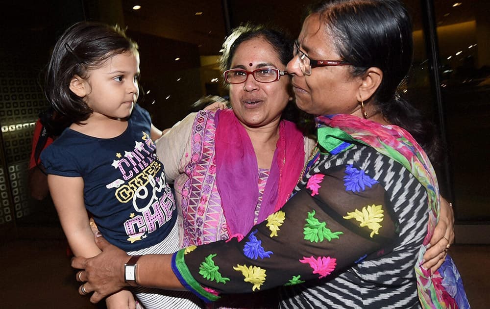 A relative receives one of the Indian nationals evacuated from Yemen, upon their arrival at the International Airport in Mumbai .