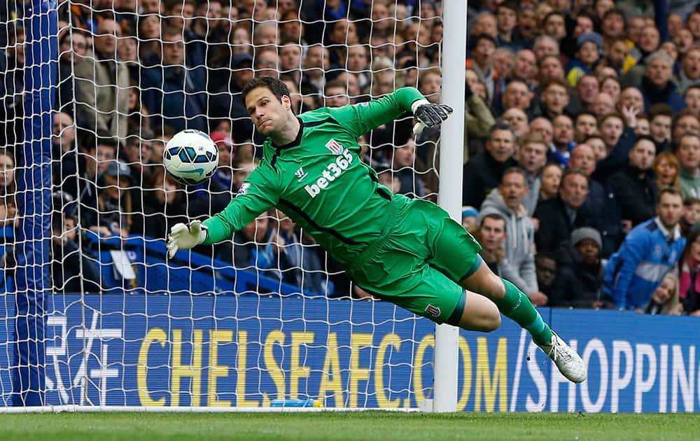 Stoke's Asmir Begovic makes a save during the English Premier League soccer match between Chelsea and Stoke City at Stamford Bridge stadium in London.
