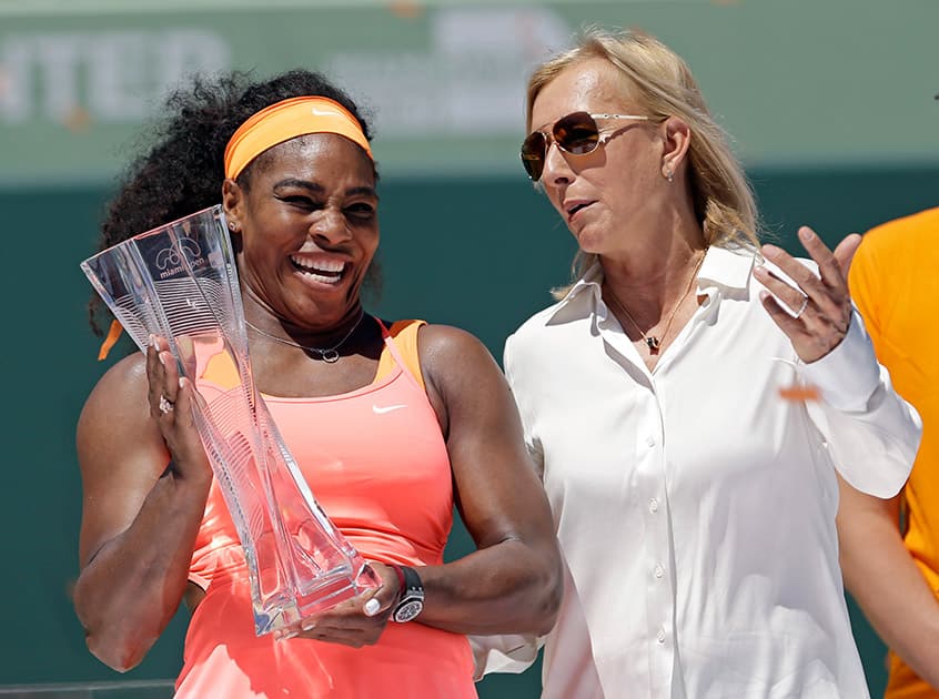 Serena Williams and Martina Navratilova pose for photographers after the women's final match at the Miami Open tennis tournament.