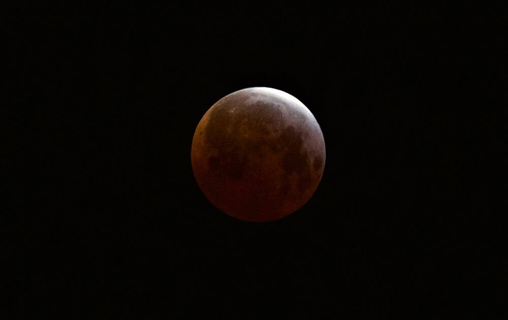 A lunar eclipse is observed as seen from Echo Park district of Los Angeles.