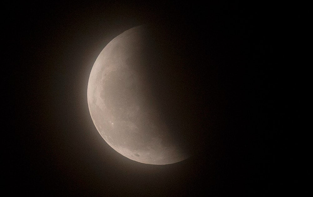 The moon is seen during a lunar eclipse phase, Beijing.