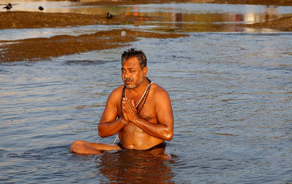 A Hindu performs rituals during a lunar eclipse in the Arabian Sea in Mumbai.