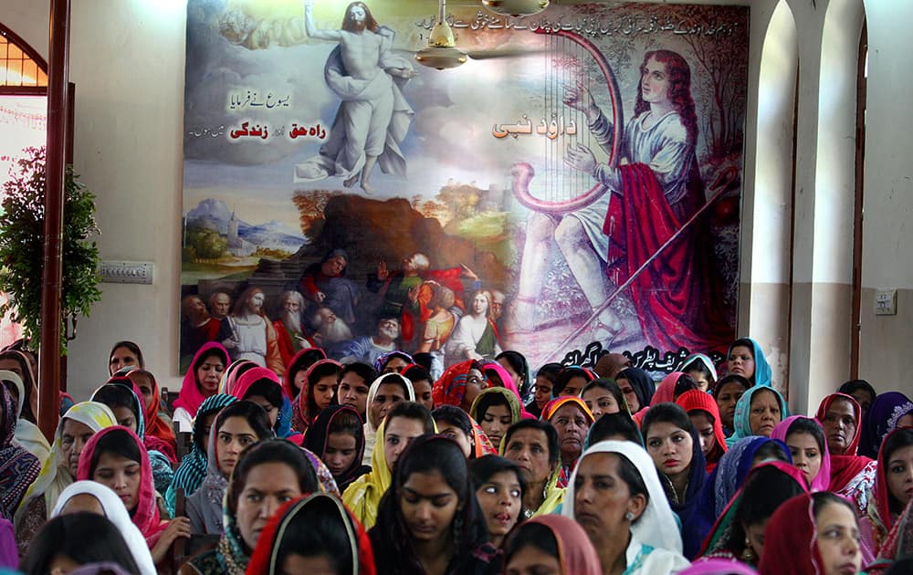 Christians pray during Easter service at St. Oswald's Church in Lahore, Pakistan.