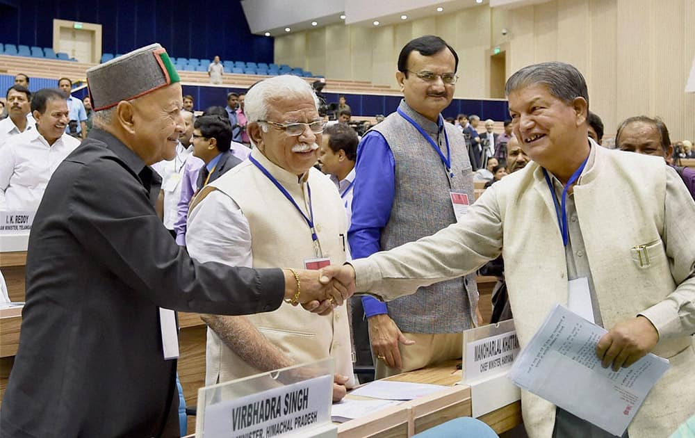 Himachal Pradesh CM Virbhadra Singh shakes hand with Uttarakhand CM Harish Rawat during the inauguration of the joint conference of the CMs and the CJs of High Courts at Vigyan Bhawan in New Delhi.