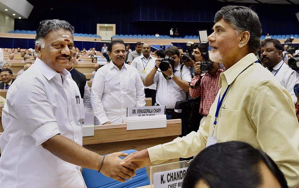 Andhra Pradesh CM N Chandrababu Naidu shakes hand with Tamil Nadu CM O Panneerselvam during the inauguration of the joint conference of the CMs and the CJs of High Courts at Vigyan Bhawan in New Delhi.