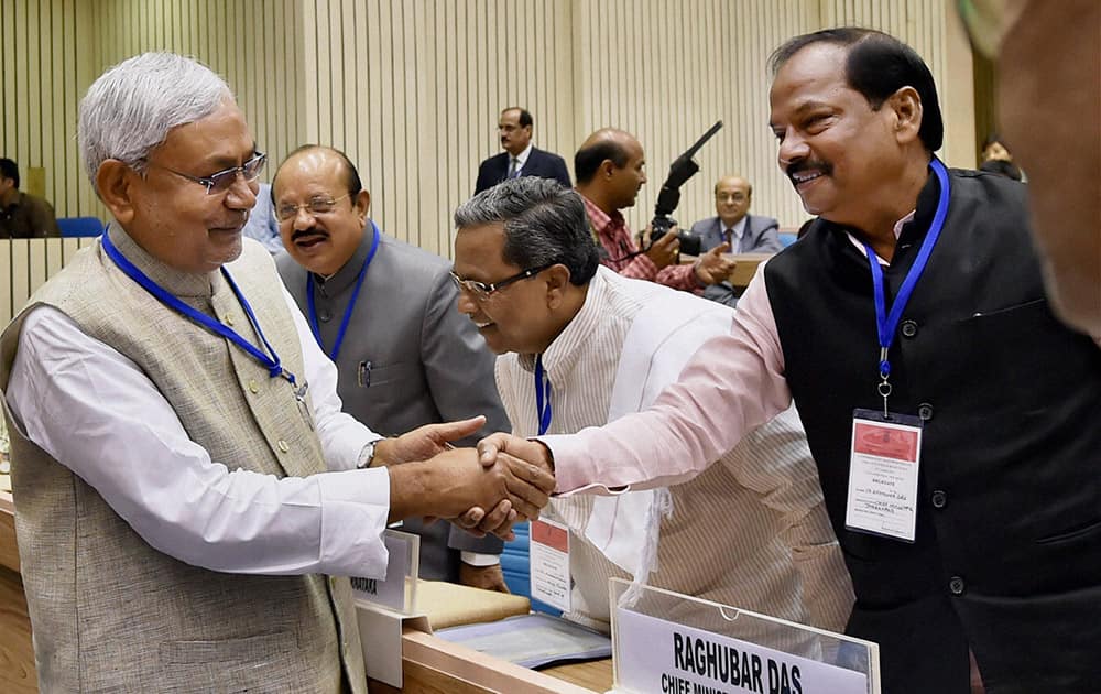 Bihar CM Nitish Kumar shakes hand with Jharkhand CM Raghuvar Das during the inauguration of the joint conference of the CMs and the CJs of High Courts at Vigyan Bhawan.