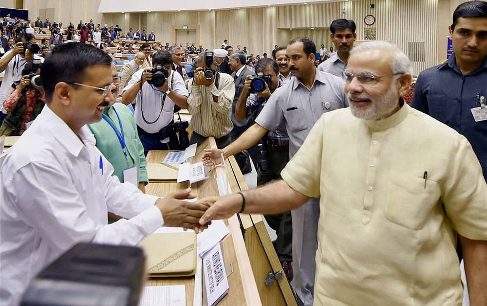 Prime Minister Narendra Modi shakes hand with Delhi CM Arvind Kejriwal during the inauguration of the joint conference of the CMs and the CJs of High Courts at Vigyan Bhawan in New Delhi.