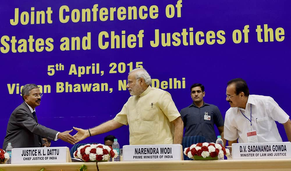 Prime Minister Narendra Modi shakes hand with Chief Justice of India H L Dattu during the inauguration of the joint conference of the CMs and the CJs of High Courts at Vigyan Bhawan in New Delhi.