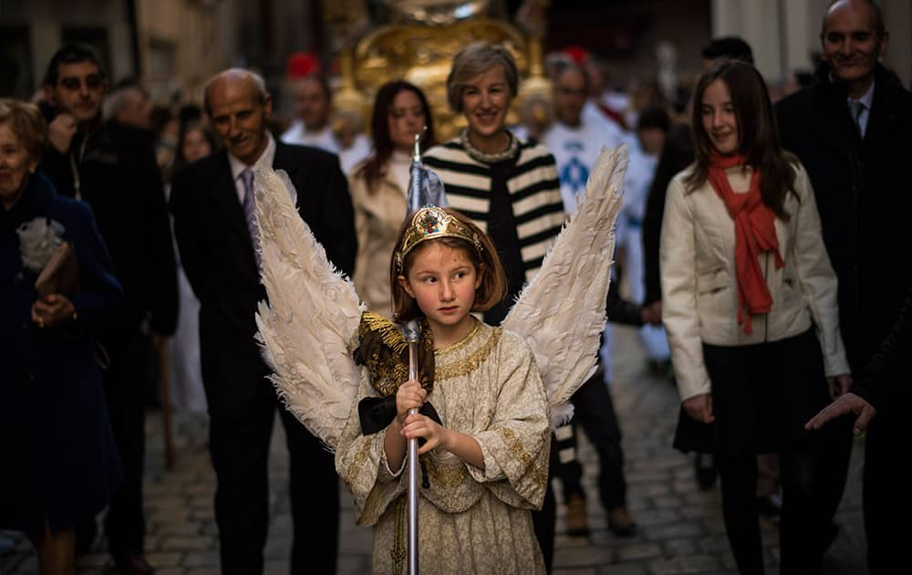 Eight-year-old Alba Oroz, wearing an angel costume takes part during the Easter Sunday ceremony 'Descent of the Angel', during Holy Week in the small town of Tudela, northern Spain.