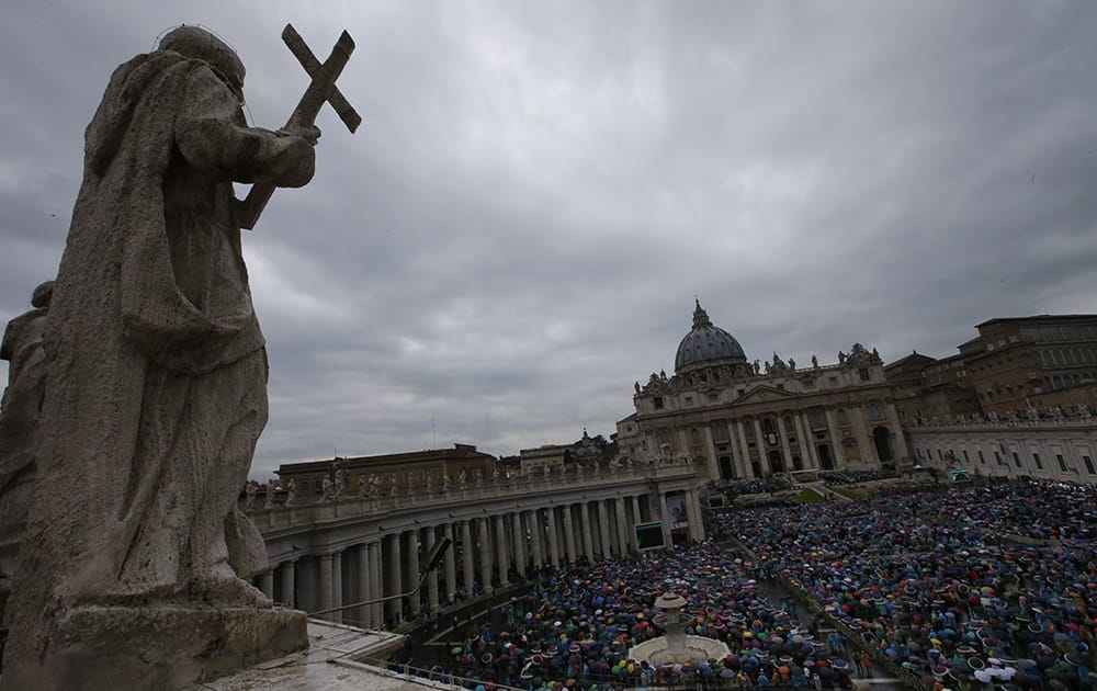 Faithful attend an Easter mass celebrated by Pope Francis, in St. Peter's square at the Vatican.