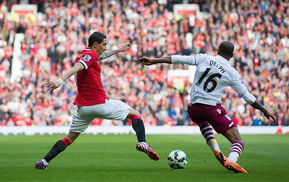 Manchester United's Angel Di Maria, left, fights for the ball against Aston Villa's Fabian Delph during the English Premier League soccer match between Manchester United and Aston Villa at Old Trafford Stadium, Manchester, England.