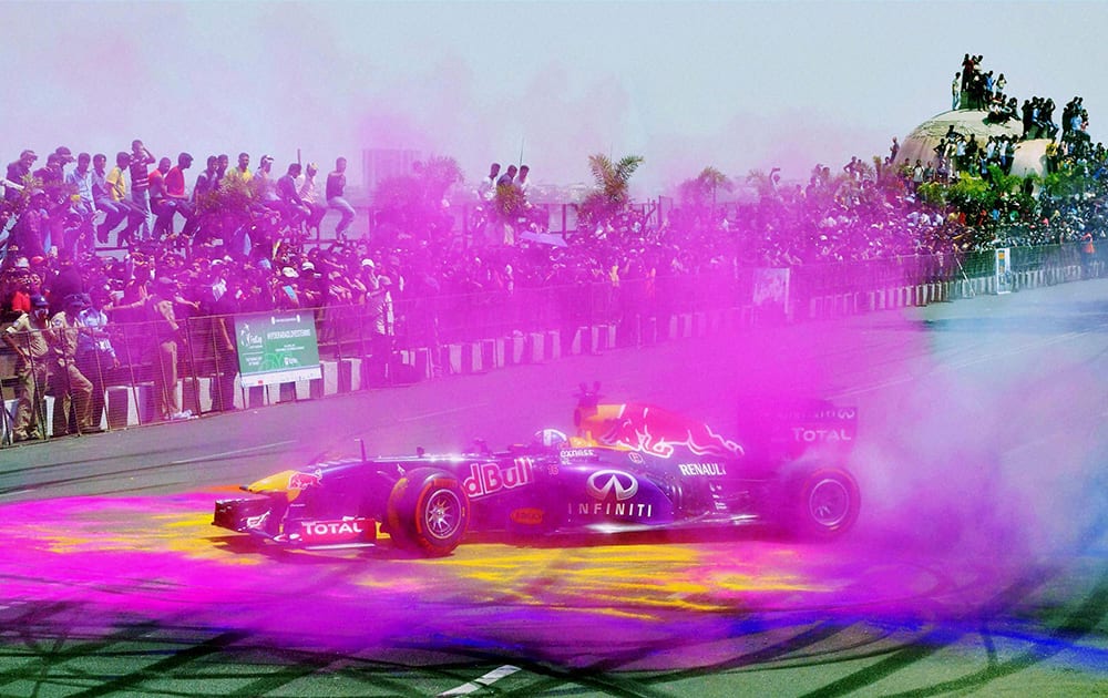 Indians watch former F1 driver David Coulthard, perform as part of an F1 show run in Hyderabad.