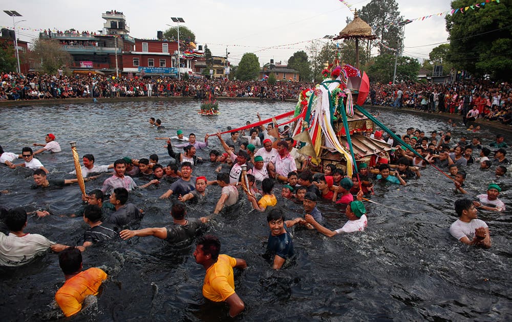 Nepalese devotees carry a chariot of Hindu goddess Tudaldevi into a pond during Gahana Khoje Jatra or Searching for lost Jewelry festival in Kathmandu, Nepal.