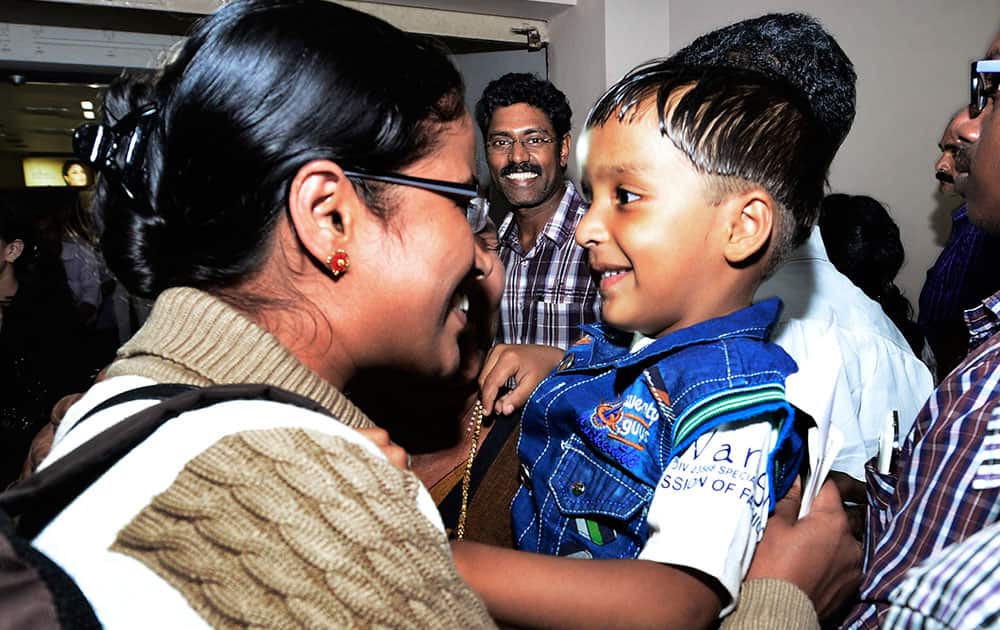 Indian nurse Tinu, left, one among the Indians evacuated from Yemen meets her son Febin upon her arrival in Kochi, India.