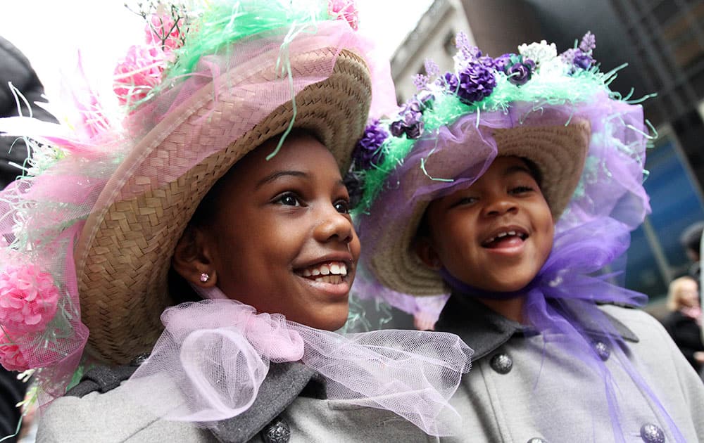 Sasha Bryant and her sister India Bryant walk in the Easter Parade along New York's Fifth Avenue.