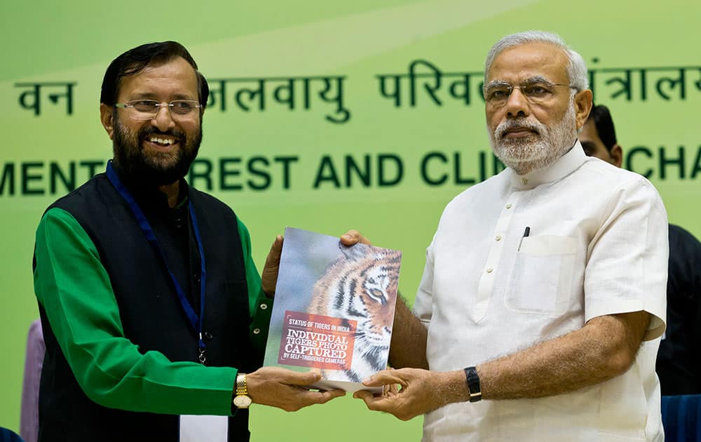 India's Minister for Environment, Forest and Climate Change Prakash Javadekar presents a copy of the latest Tiger census report to Prime Minister Narendra Modi during a conference by The Environment Ministry in New Delhi, India.