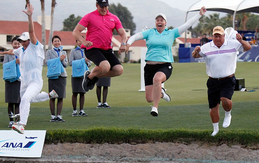 Brittany Lincicome, second from leaps into Poppy's Pond with her father, Tom Lincicome, right, her fiancé, Dewald Gouws and her caddie, Missy Pederson, left, after winning an LPGA Tour golf tournament at Mission Hills Country Club.